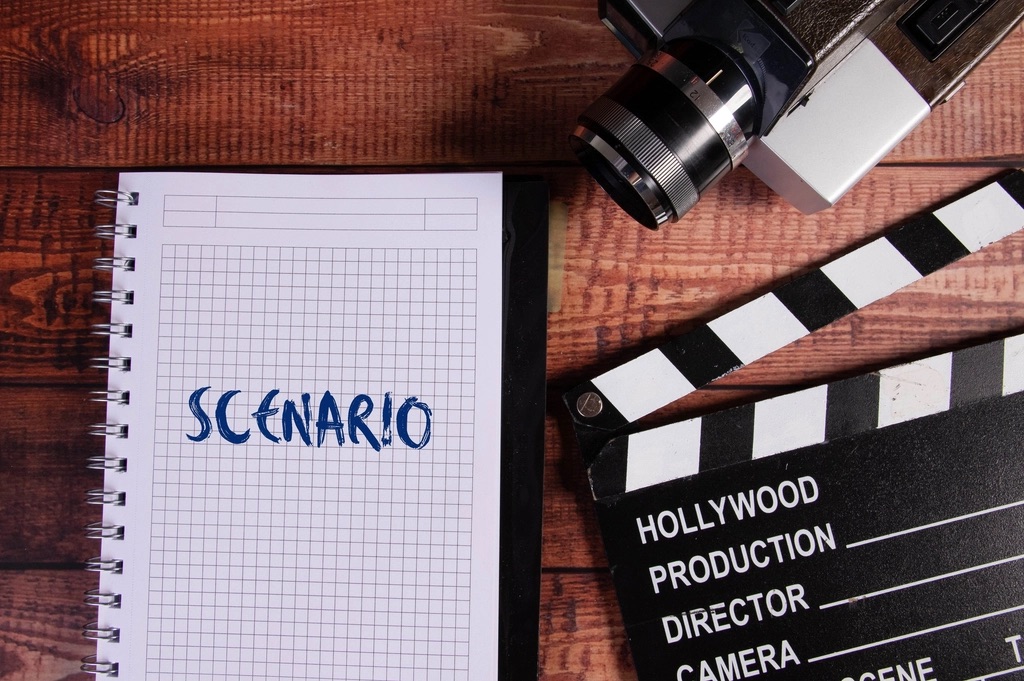 Clapperboard and a script notebook on a desk