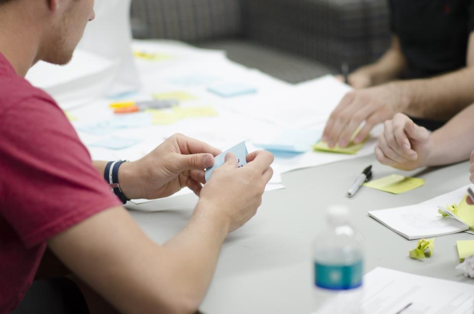 Colleagues planning with sticky notes at a meeting table