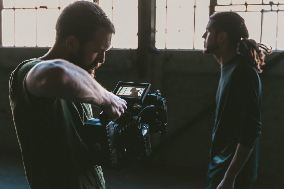 Camera operator filming with a cinema camera