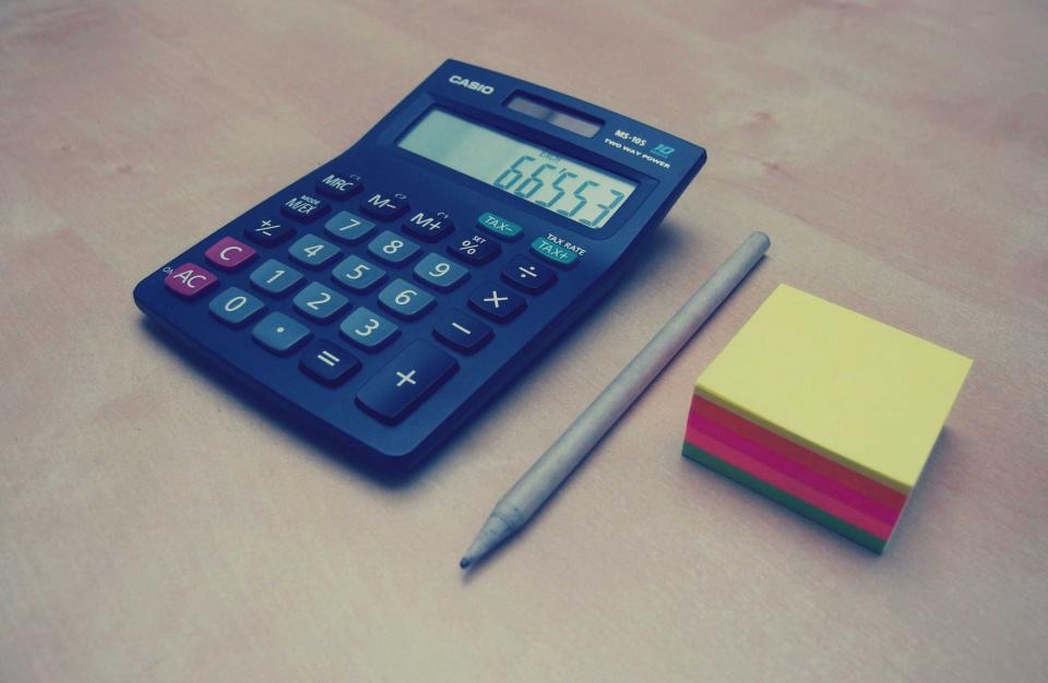 Calculator and a notepad on a desk