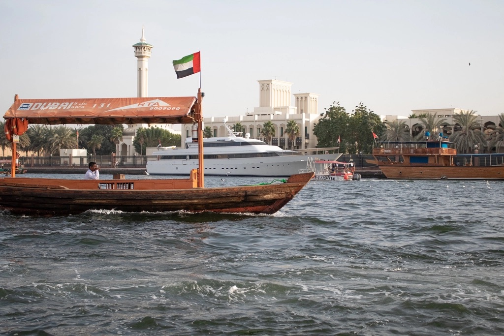 Abra boat flying the UAE flag on Dubai Creek